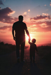 Happy Father's Day 2025: The Critical Role of a Father at Home and in Business. Silhouette of an adult and child holding hands, walking on a path at sunset. The sky is vibrant with pink and orange hues, evoking warmth and togetherness.