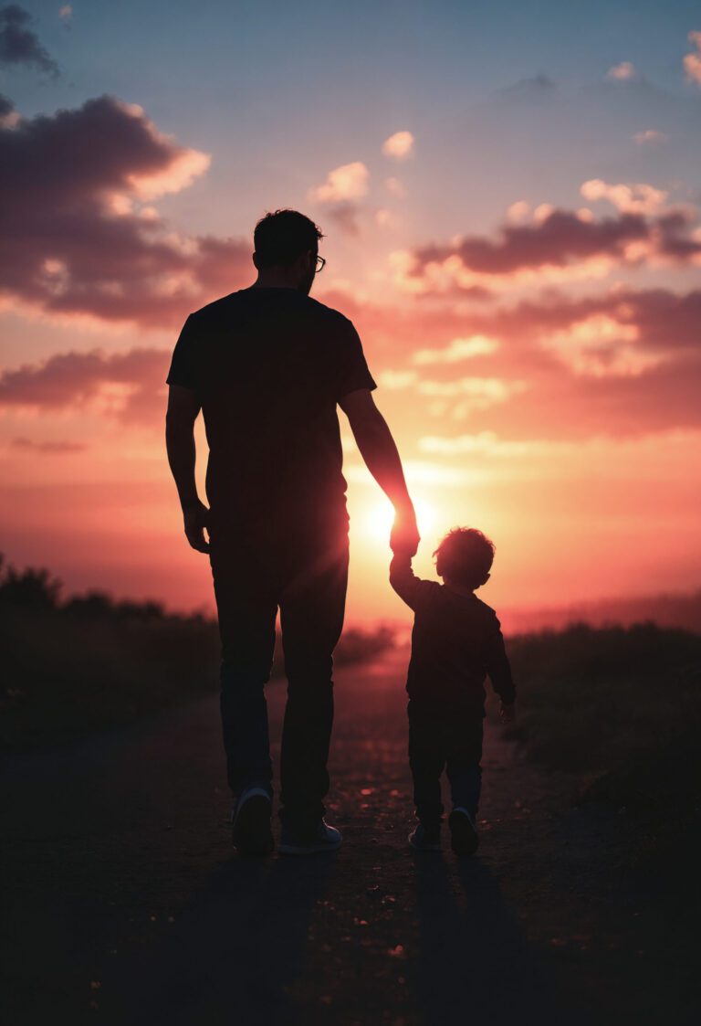 Happy Father's Day 2025: The Critical Role of a Father at Home and in Business. Silhouette of an adult and child holding hands, walking on a path at sunset. The sky is vibrant with pink and orange hues, evoking warmth and togetherness.