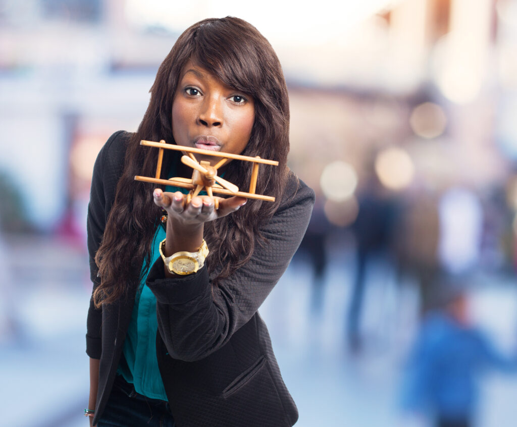 young woman with airplane in hand, demonstrating career change path